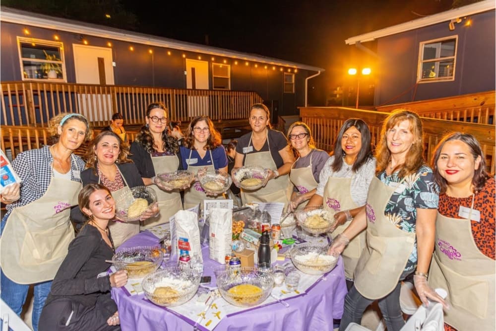 An image of women baking Challah together at a previous Austin Challah bake. 