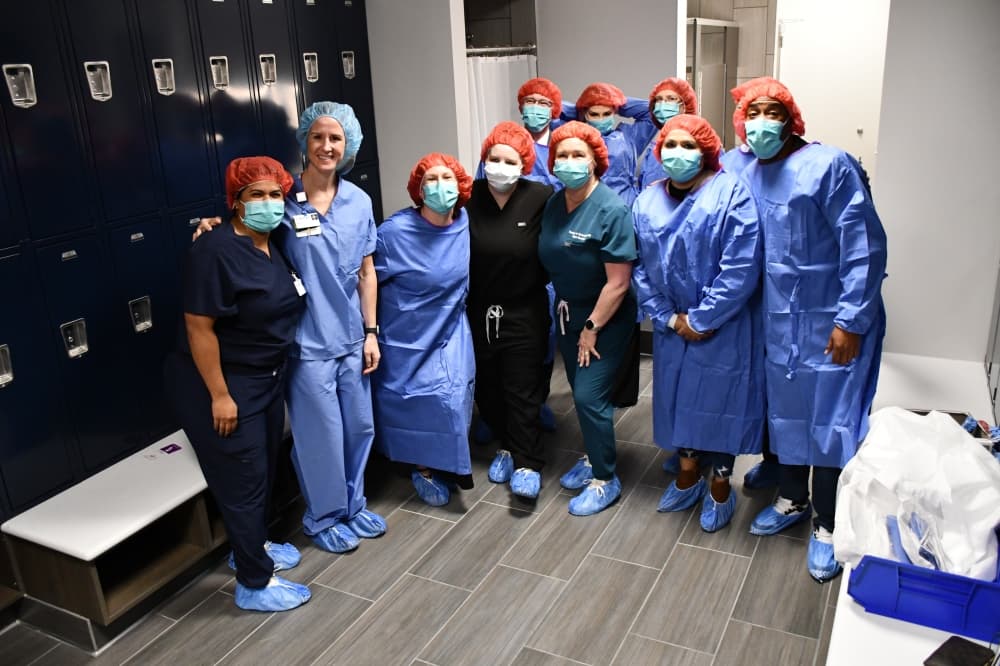 Group of officials in hospital attire