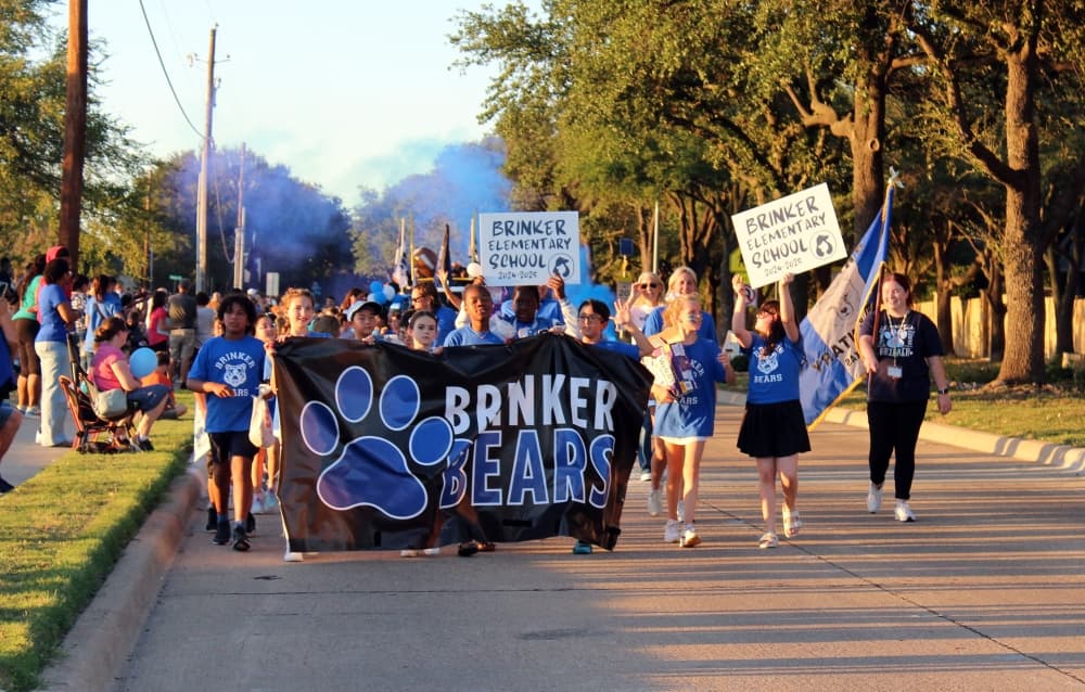 People carrying a banner in a parade. 