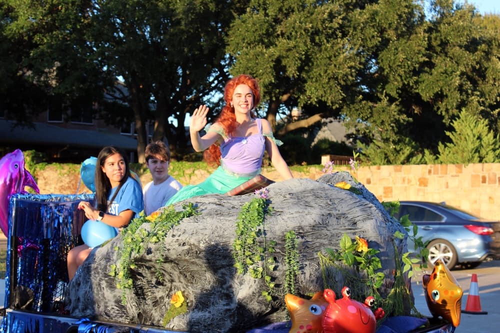 Girl dressed as Little Mermaid in a parade. 