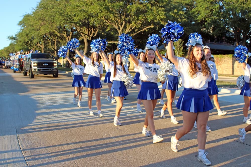 Cheerleaders marching in a parade.