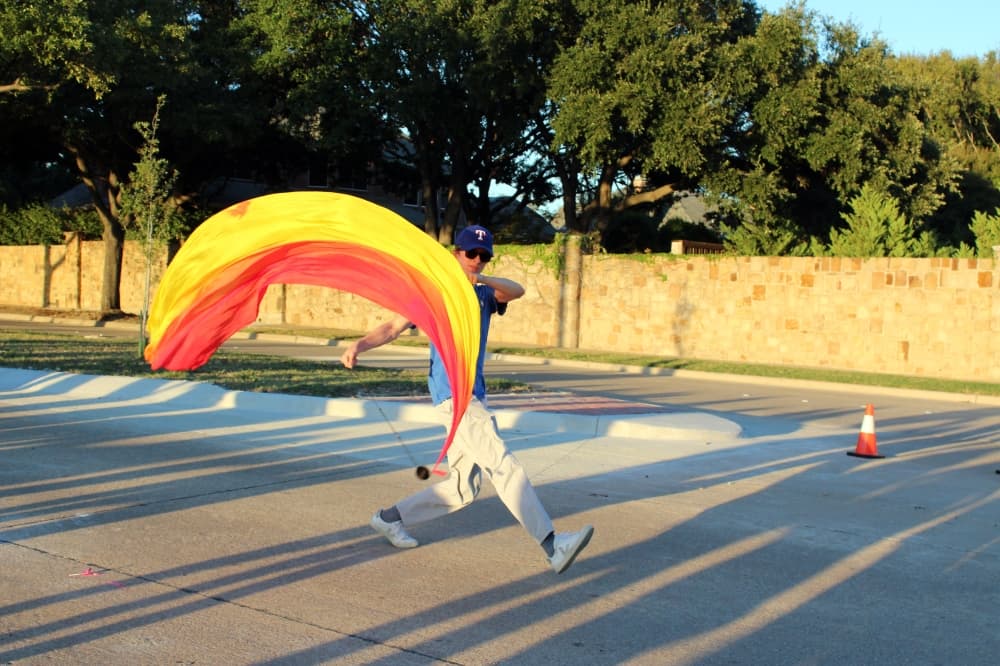 Male twirling flag in a parade. 
