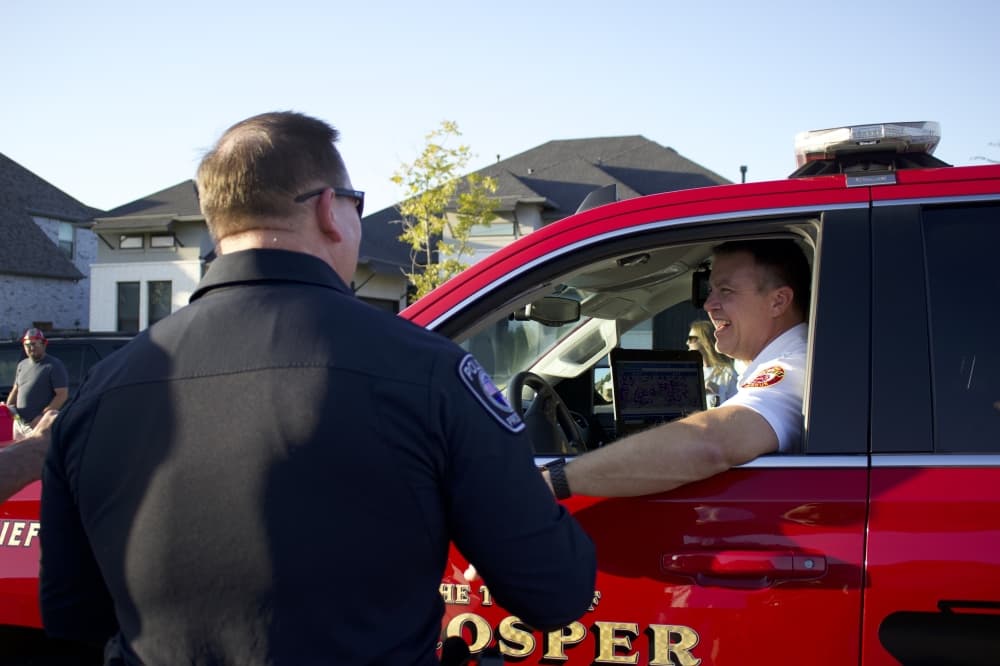 Assistant Chief of Police Scott Brewer speaks with a member of the Prosper Fire Department. (Alex Reece/Community Impact)
