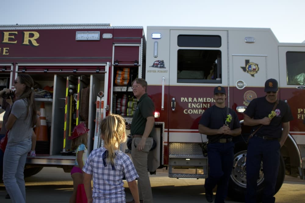 Children stand around a Prosper fire truck. (Alex Reece/Community Impact)