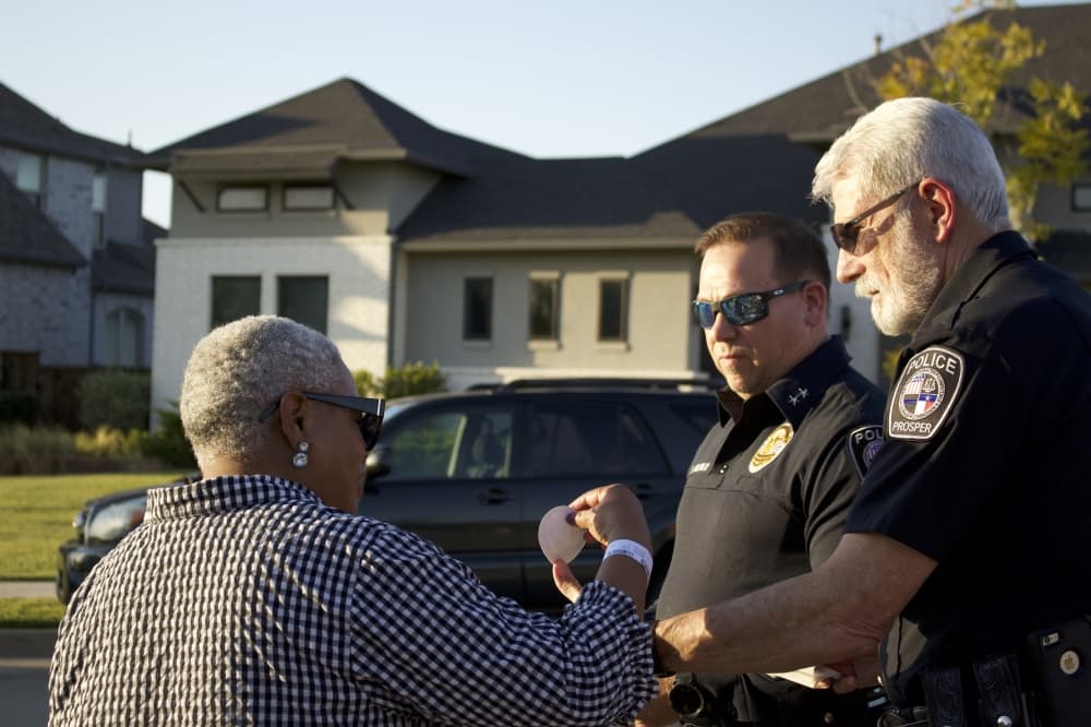Prosper Police Chief Kowalski and Assistant Chief Brewer speak with a resident at an Oct. 1 National Night Out event. (Alex Reece/Community Impact)