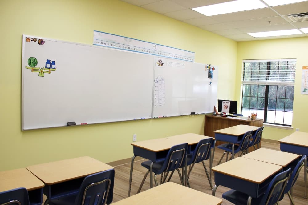 Classroom with desks and marker board. 