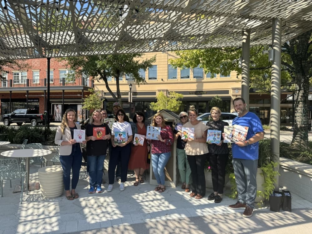 People gather with books