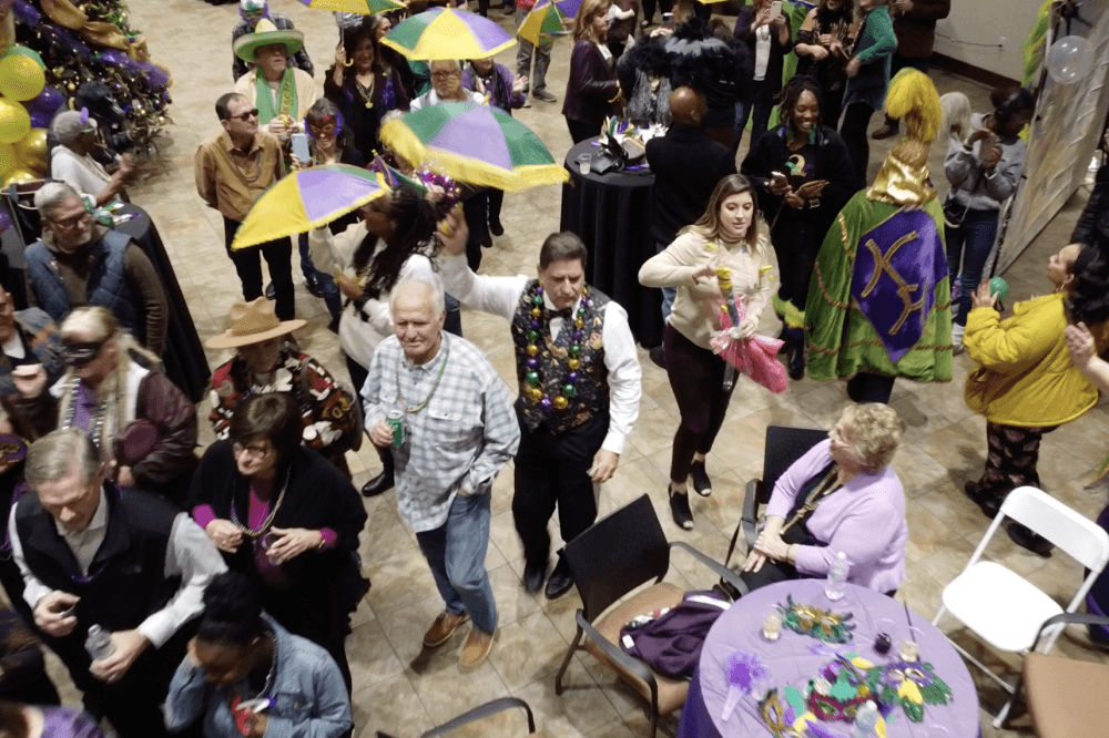 A Mardi Gras celebration at the dealership is shown.