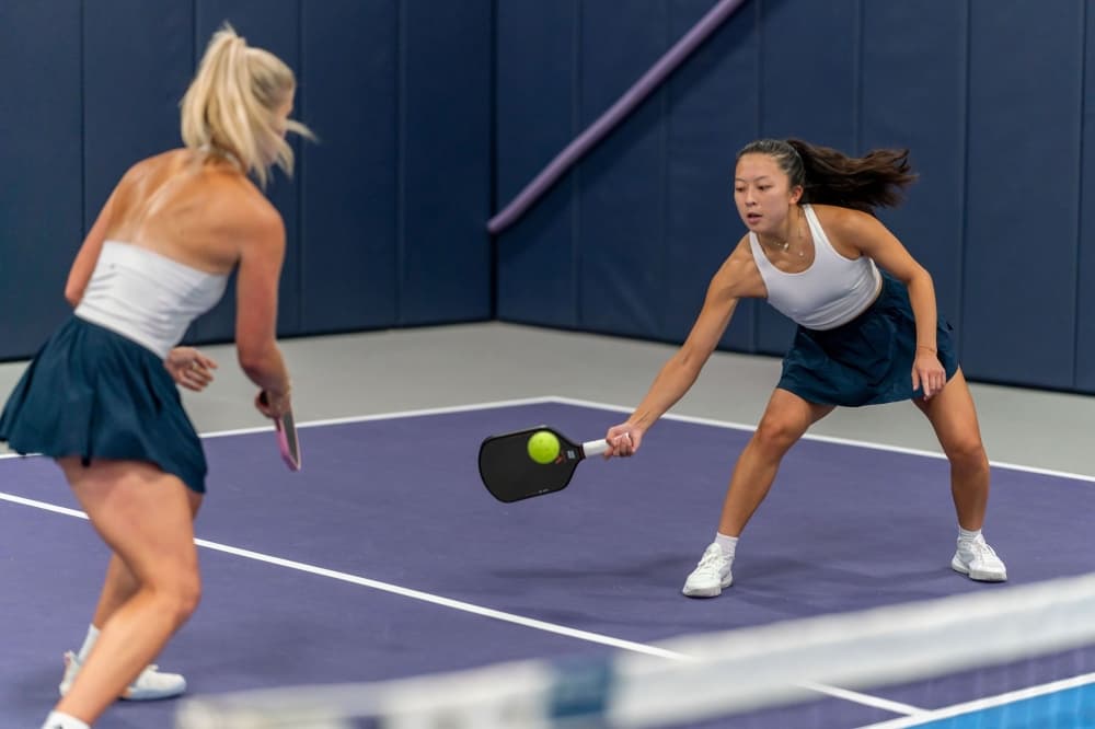 An image of two pickleball players at the facility during a match. 