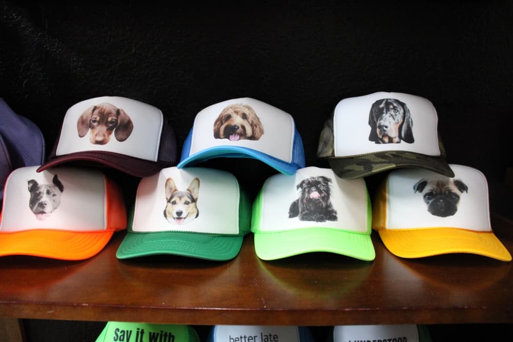 Several hats with pictures of dogs on them. 