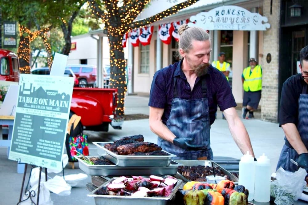 The owner mans an event on Main Street downtown.