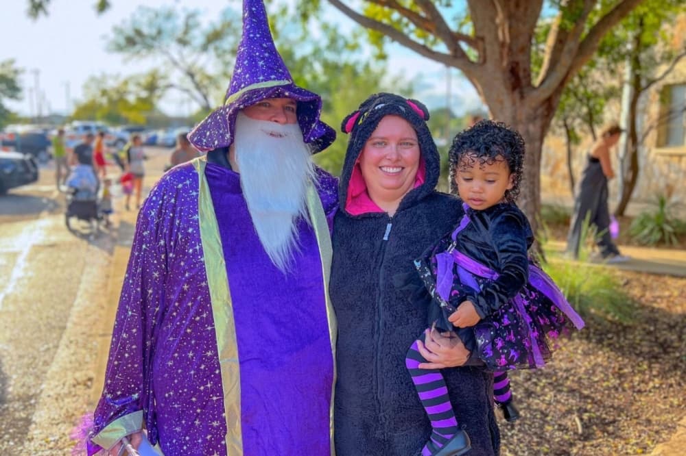 An image of a family at a previous Trick or Treat Trail dressed up in costume. 