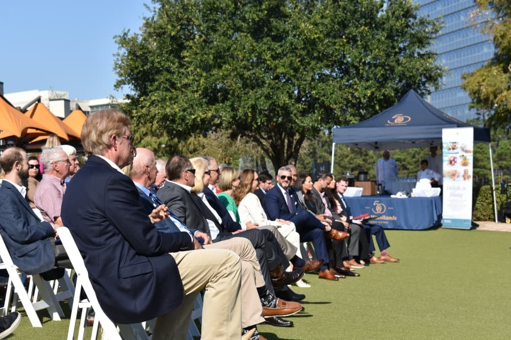 A row of people in outdoor seating
