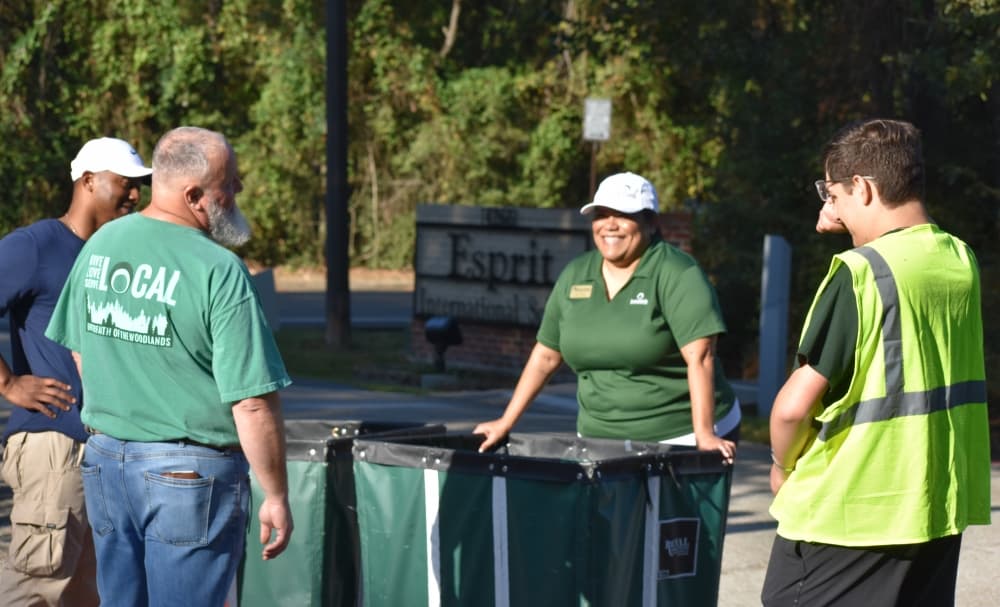 Volunteers gather around bins