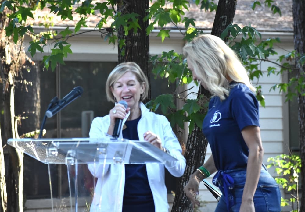 Two women at a podium 