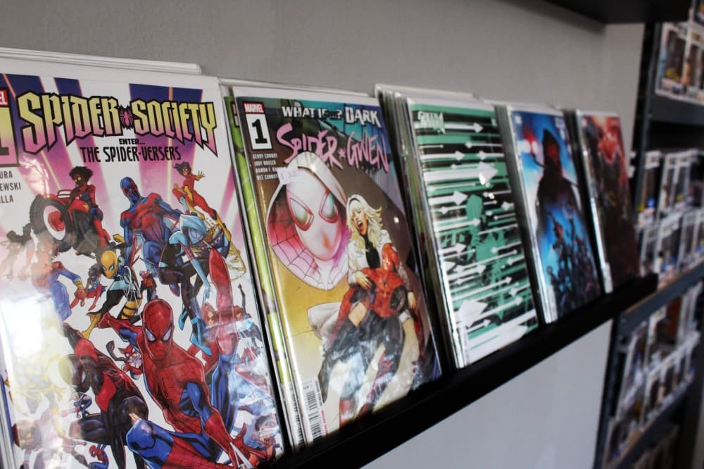 Comic books displayed on a shelf. 