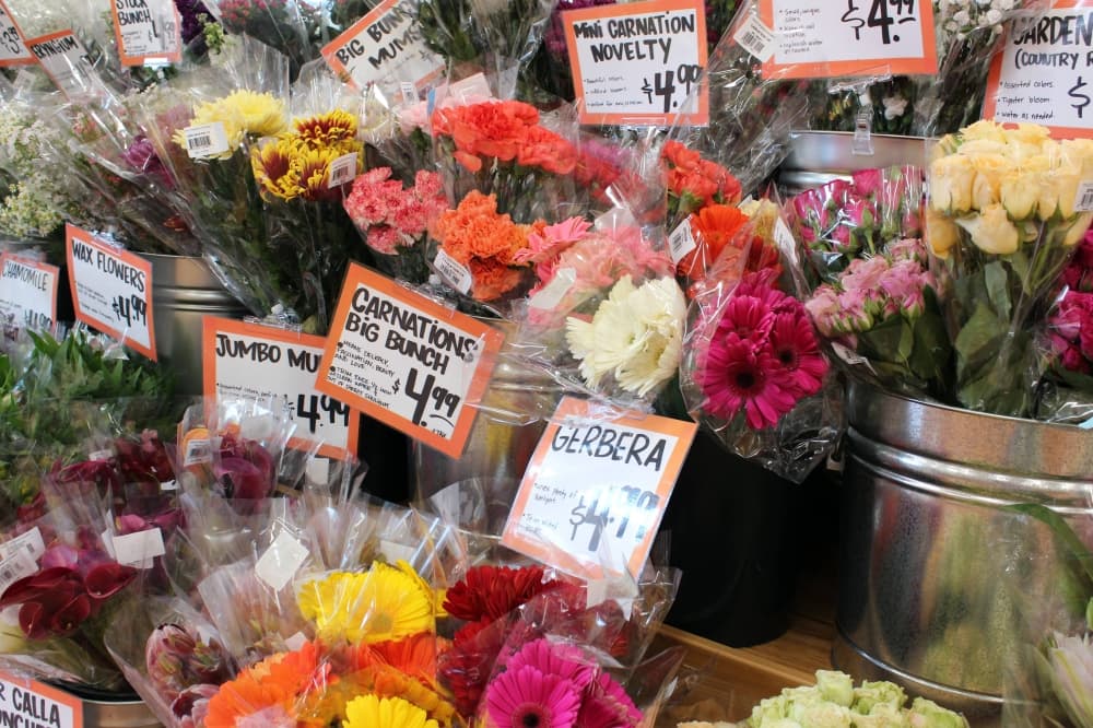 Flowers in bunches with prices on cards. 