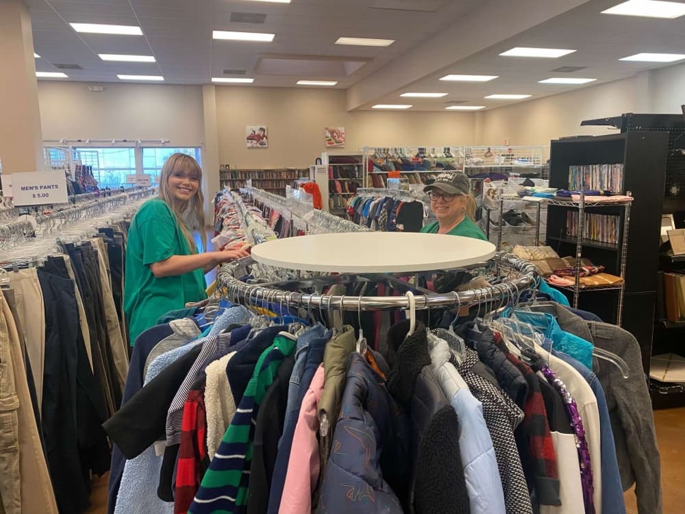 An image of volunteers sorting through clothing. 