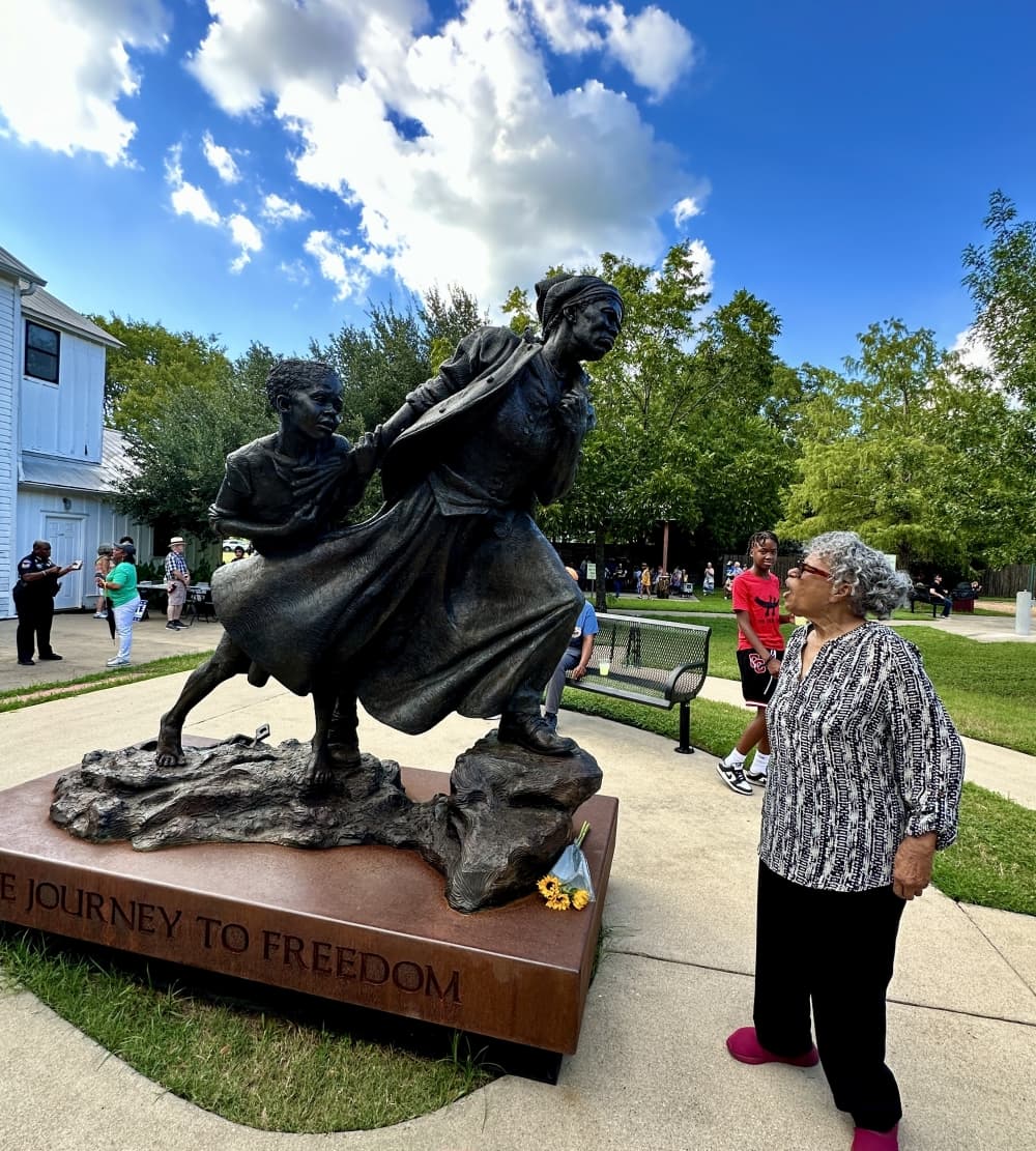 The woman stands in awe and gasps as she sees the monument.