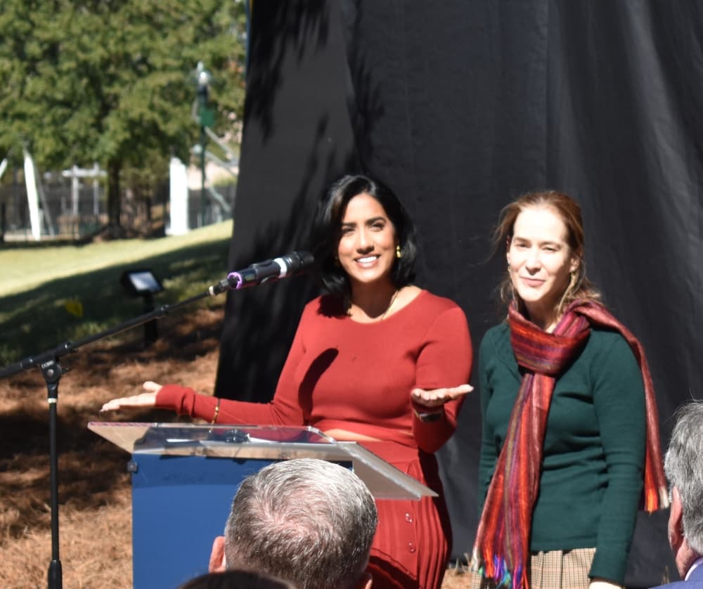 two women speaking at podium