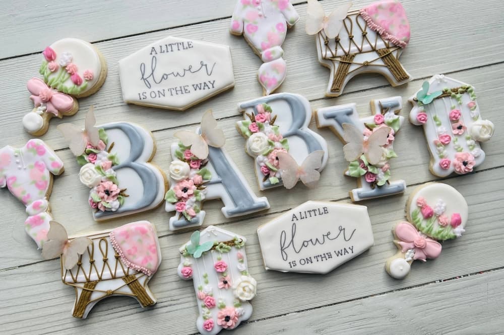 Variety of decorative cookies with a baby shower theme.