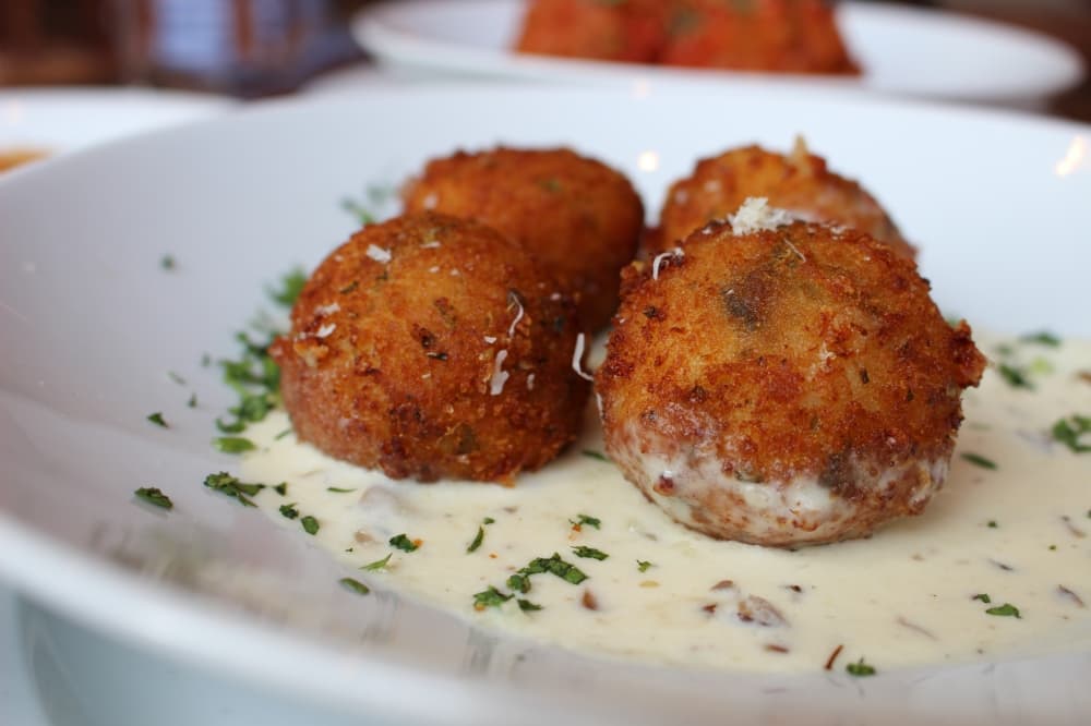 Arancini ($13) is a fried risotto ball stuffed with risotto, mozzarella, truffled fontina and parmesan. (Asia Armour/Community Impact)