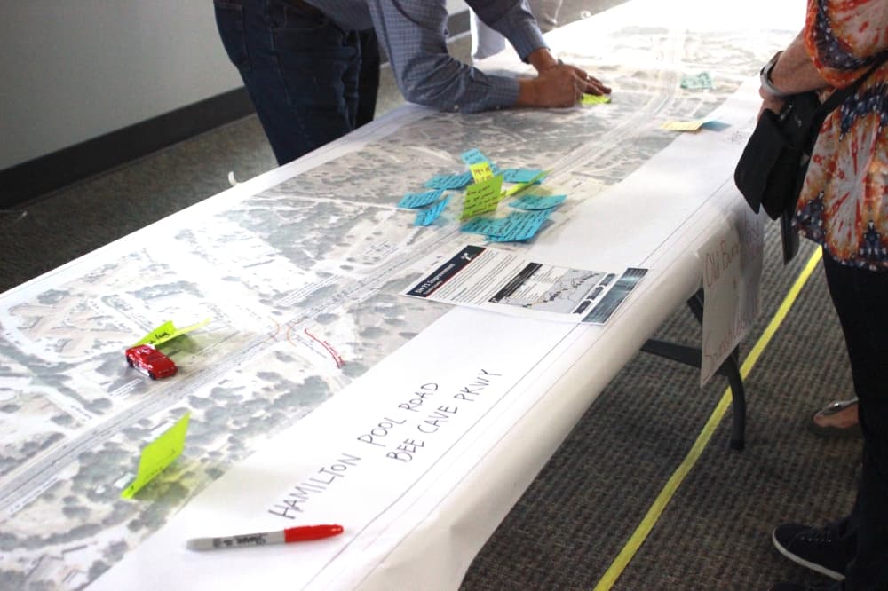 man writing on map