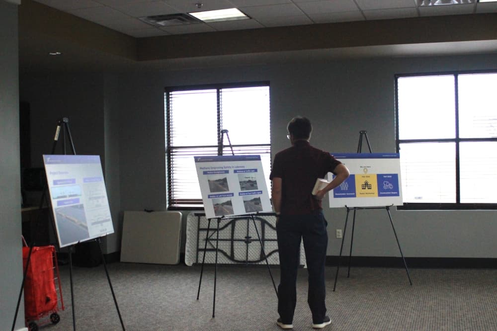 man standing at poster board
