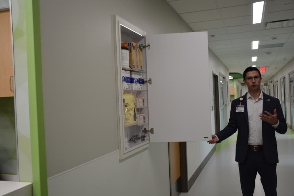 Graham Torres, Children’s Health vice president of facilities operations, shows off a personal protective equipment closet within the new 8-story tower at Children's Medical Center Plano. 