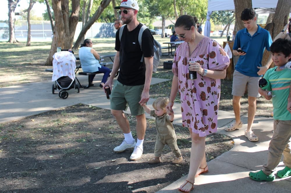 Parents walking with their young son. 