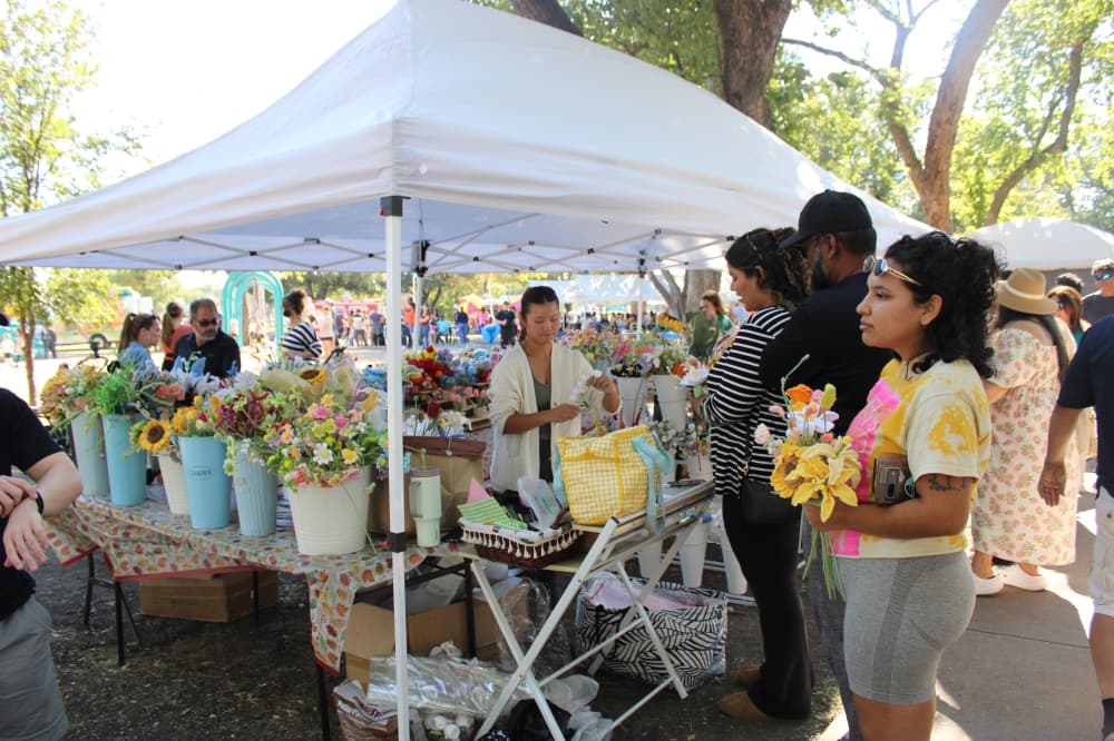 People buying items at a vendor booth