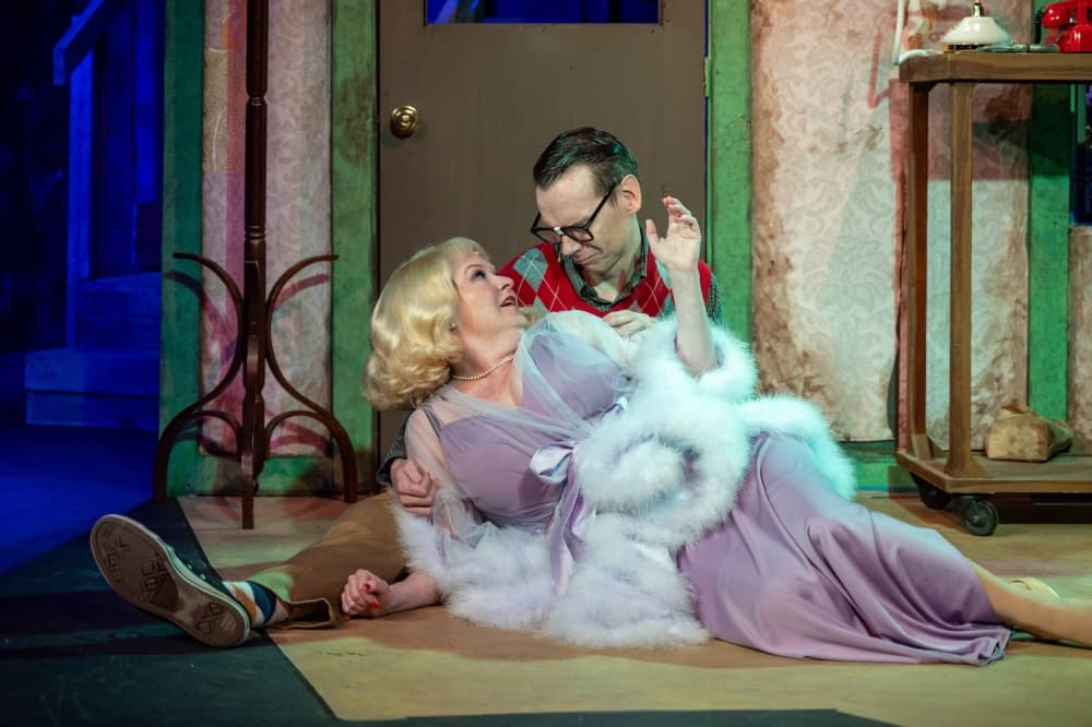 Male and female on stage in a play. 