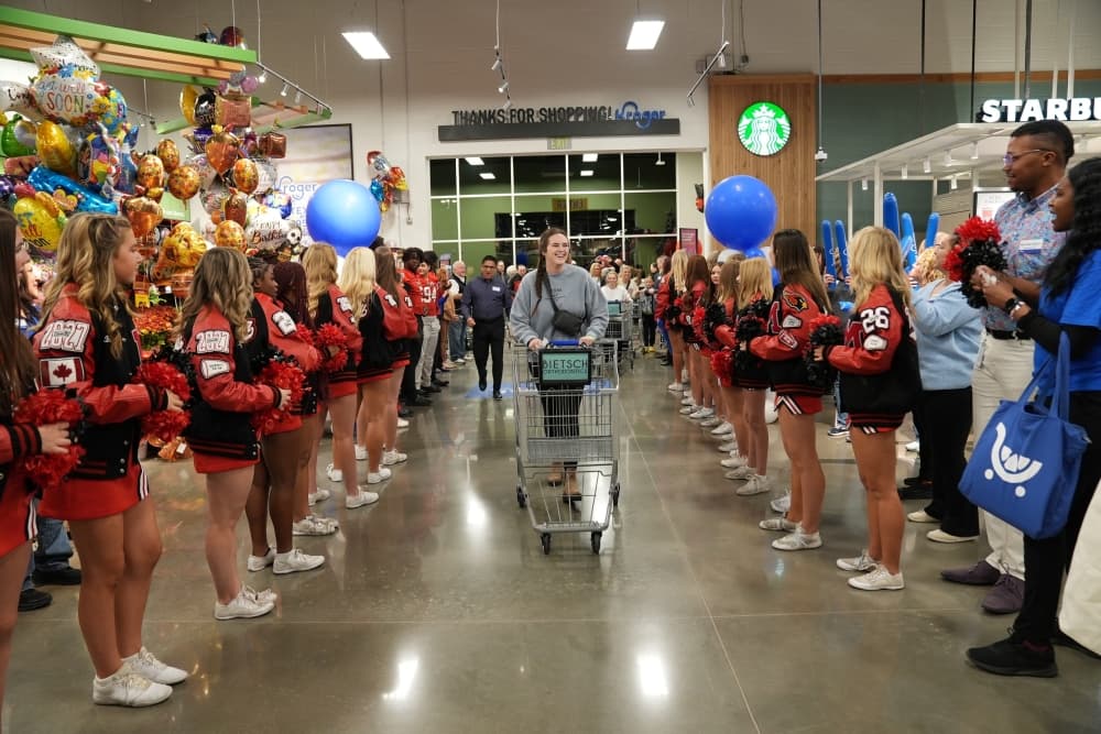 Woman walking into a Kroger store