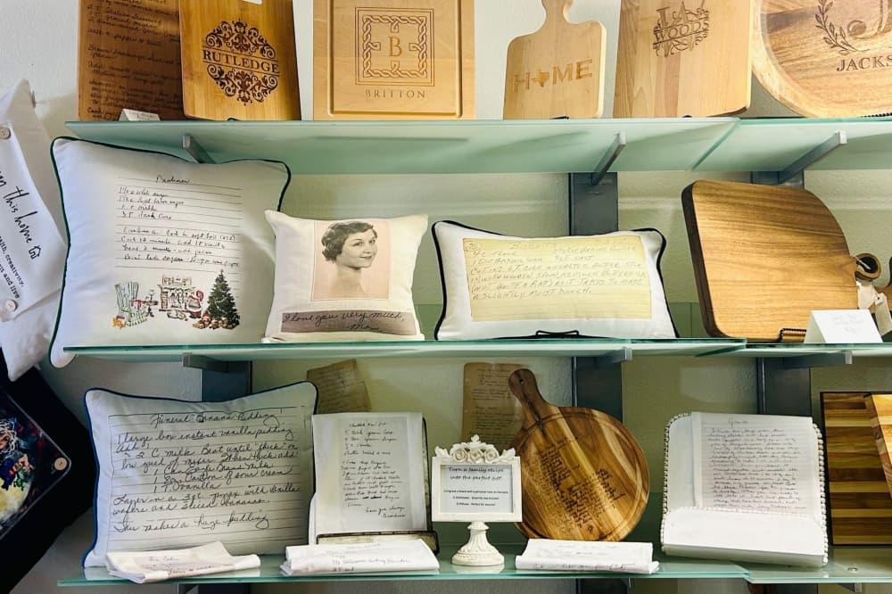 An image of the customizable gifts sold at the shop including pillows and wood boards. 