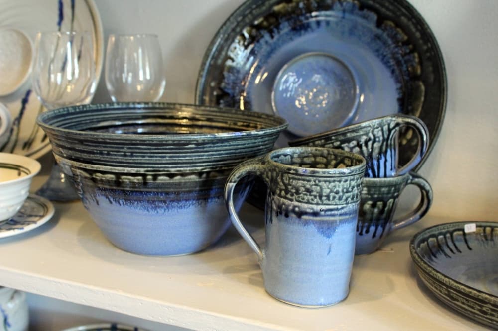 Various pieces of pottery featuring shades of blue and green glaze. 