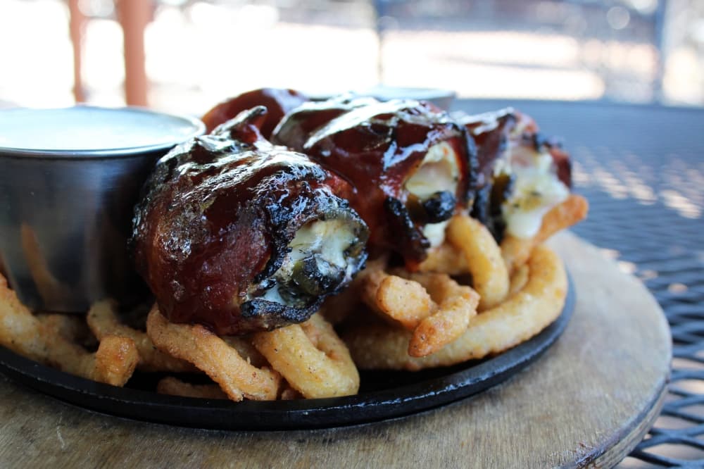 Plate of jalapeno poppers and fries. 