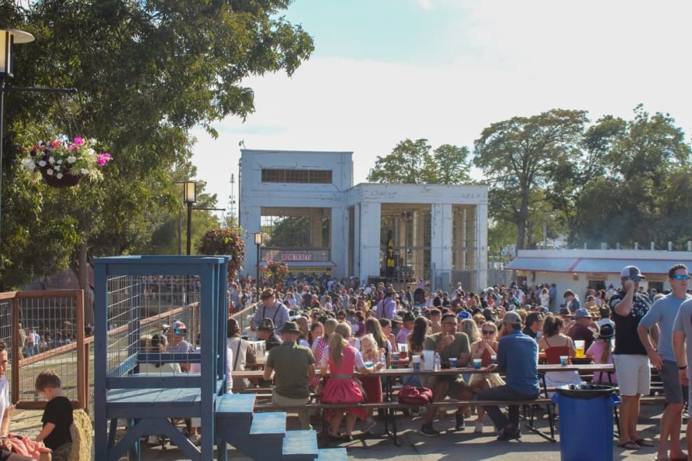 The Wurstfest grounds, located near Landa Park and downtown New Braunfels on the Comal River, are often packed with people attending the festival at peak times, as seen here in 2023. (Sierra Martin/Community Impact)