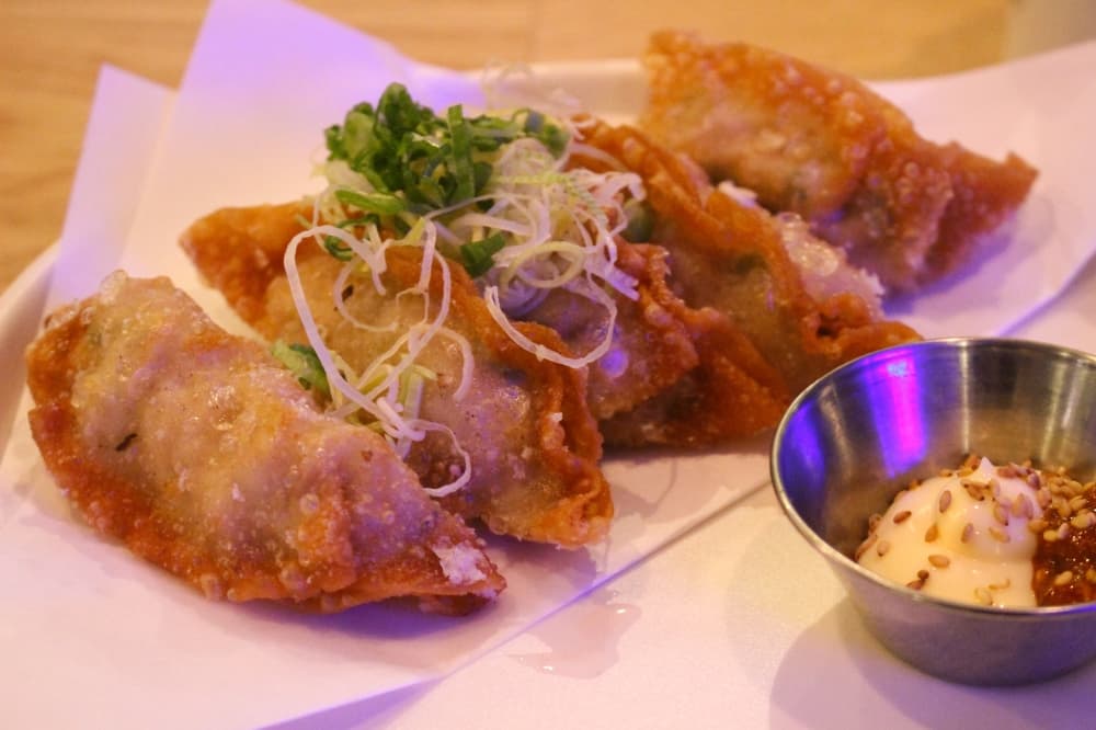 Crispy Buta Gyoza is a fried pork dumpling made with with leeks, scallion and mayo and served with a side of house chili sauce. (Cassandra Jenkins/Community Impact)