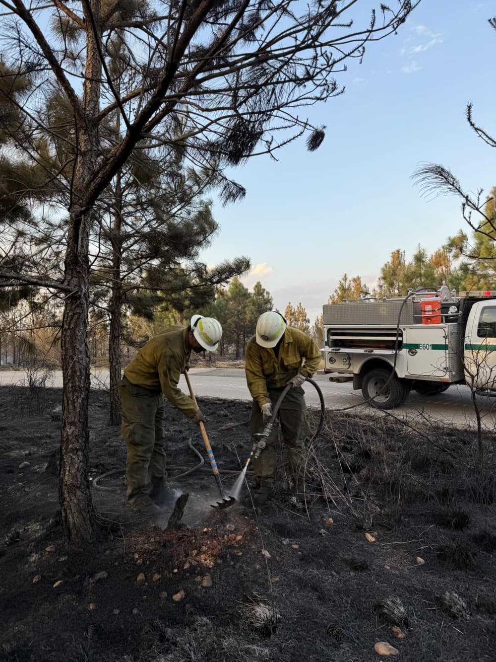 Two people mop up the site.