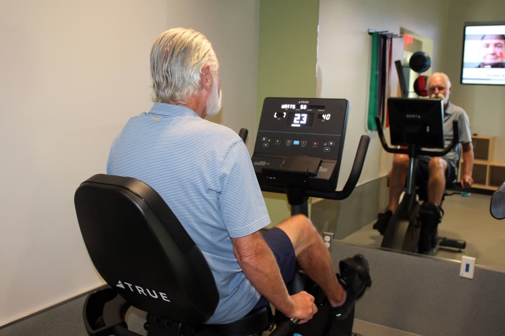 Male using a stationary bike.