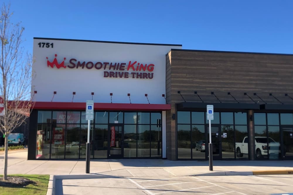 Exterior of a building with Smoothie King sign. 