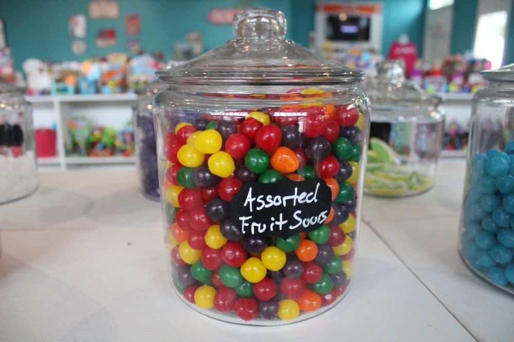 Assorted fruit sour candies in a bin