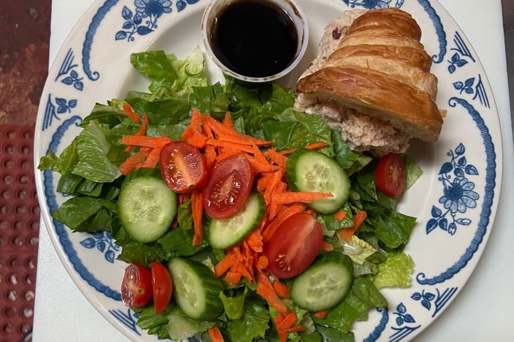 An image of a salad and sandwich option served at the restaurant. 