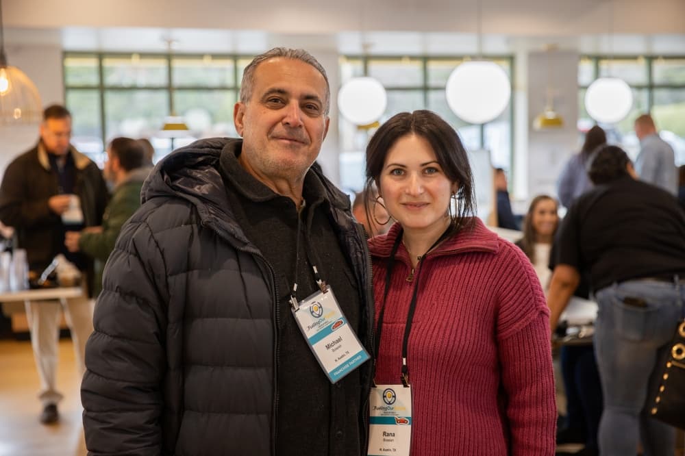 A man and a woman smile for a photo