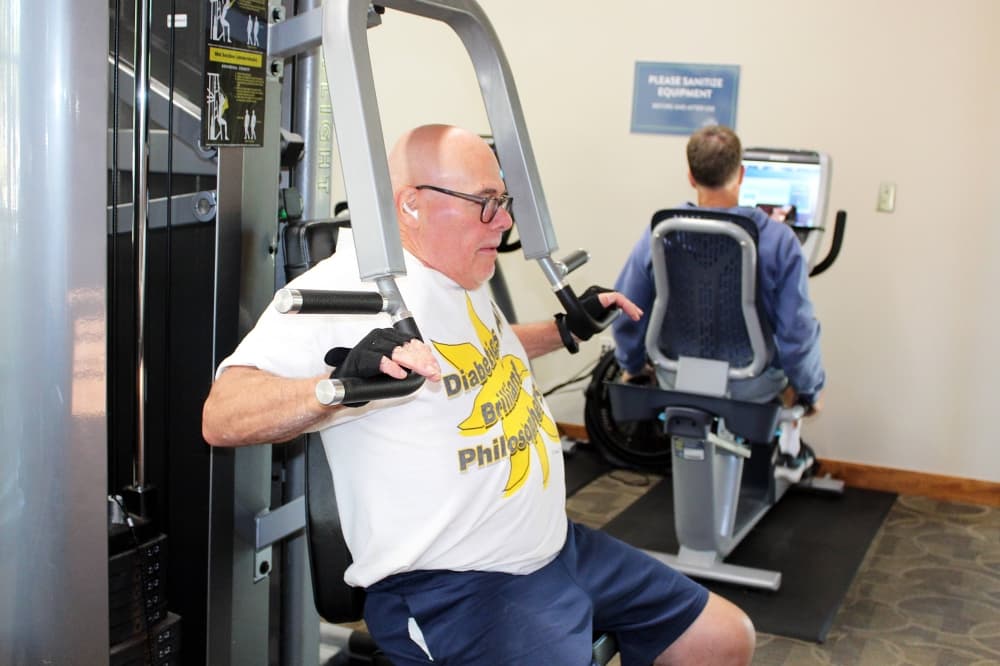 Male using a weight machine. 
