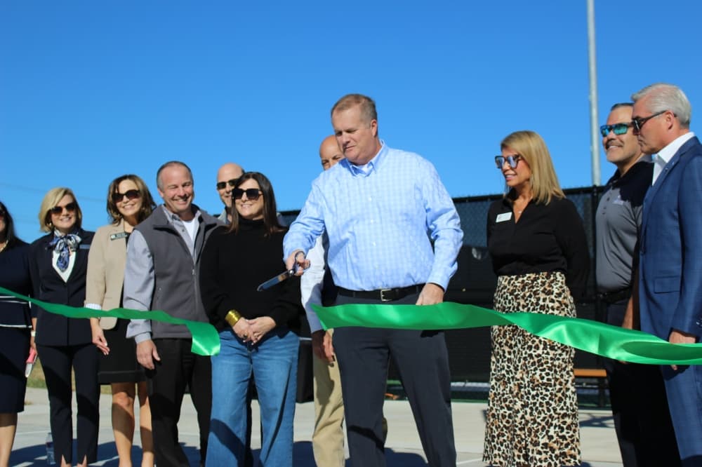Parks and Recreation Advisory board member Daniel Knox cuts the ribbon to officially open Lakewood Park. (Alex Reece/Community Impact) 

 