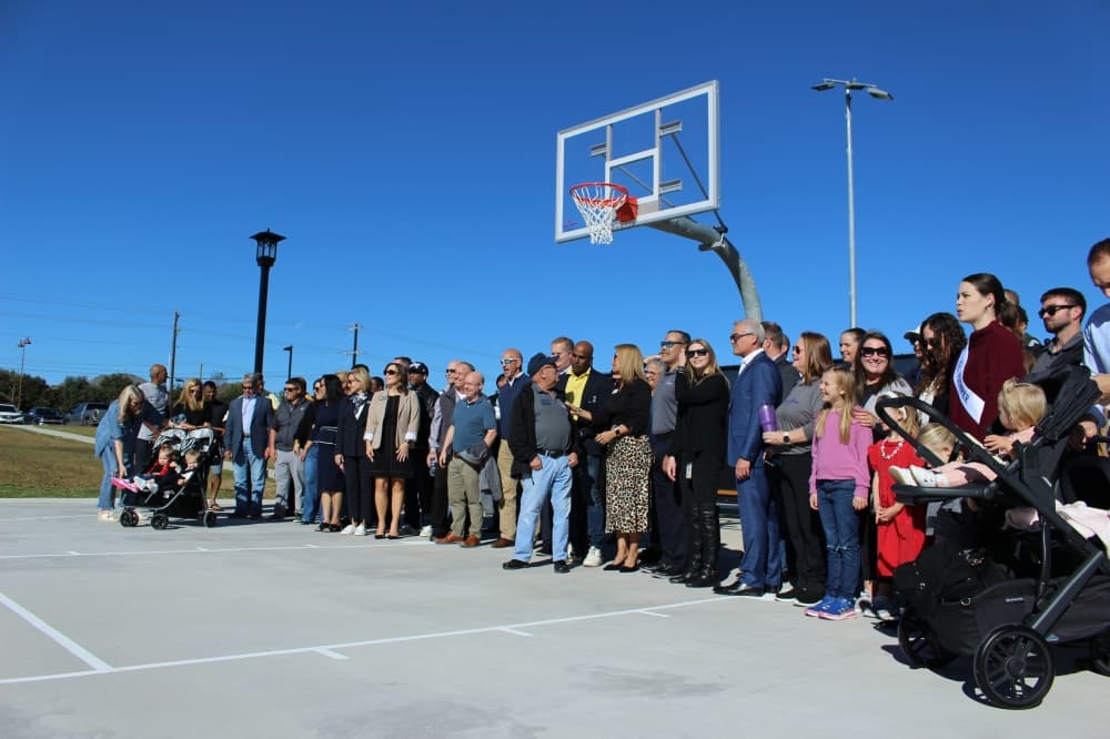 Multiple residents and town officials attended the ribbon cutting ceremony for Lakewood Park. (Alex Reece/Community Impact)