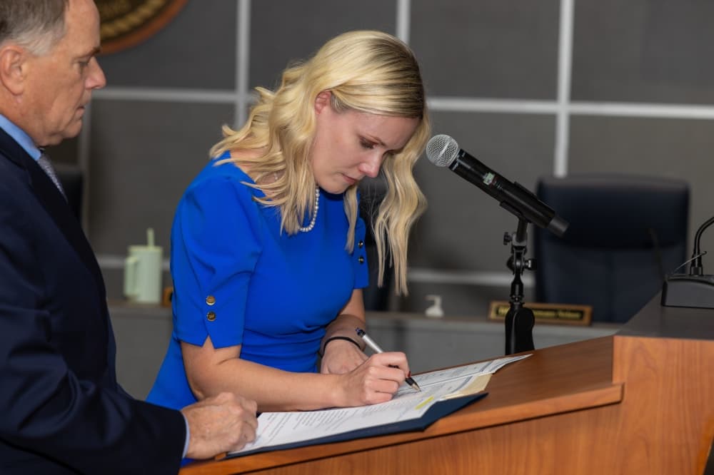 woman signing a document