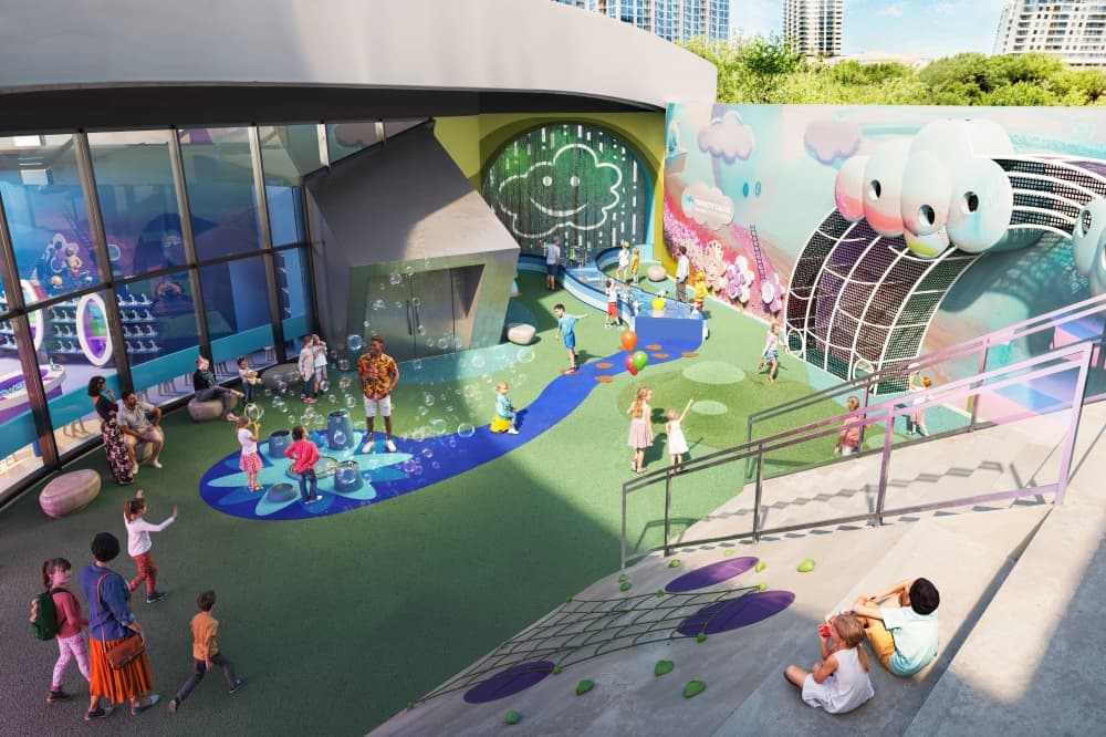 Rendering of an outdoor space with seating and interactive elements for children. 