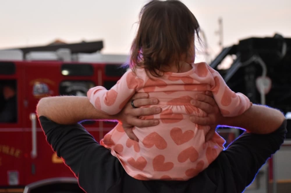 man with a child on his shoulders